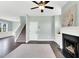 Inviting living room with cozy fireplace and modern ceiling fan creates a comfortable space at 97 Arapahoe Dr, Kenly, NC 27542