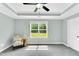 Spacious main bedroom with tray ceiling, plush carpet and ceiling fan at 97 Arapahoe Dr, Kenly, NC 27542