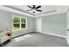 Spacious main bedroom with tray ceiling, plush carpet and ceiling fan at 97 Arapahoe Dr, Kenly, NC 27542