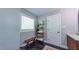 Bright bathroom offers modern shower, tiled floors, decor shelving, and a linen bench at 973 Rebecca Ln, Siler City, NC 27344