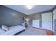 This bedroom features wood floors, gray walls, a desk, and natural light at 973 Rebecca Ln, Siler City, NC 27344