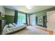 Bright bedroom featuring a plush rug, a large window and view of the outside at 973 Rebecca Ln, Siler City, NC 27344