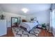 Bright bedroom boasts wood floors, neutral decor, a large mirror and a comfy rug at 973 Rebecca Ln, Siler City, NC 27344