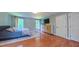 Bright bedroom featuring hardwood floors, a TV, and a closet for storage at 973 Rebecca Ln, Siler City, NC 27344