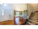 Elegant dining area with hardwood floors, stylish wallpaper, and a modern staircase at 973 Rebecca Ln, Siler City, NC 27344