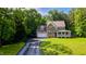 Traditional two-story home with brick and siding exterior, covered porch, manicured lawn, and mature trees at 973 Rebecca Ln, Siler City, NC 27344