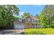 Classic two-story home featuring brick and siding exterior, covered front porch, and meticulously maintained yard at 973 Rebecca Ln, Siler City, NC 27344