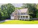 Beautiful two-story home with stone details, a cozy front porch, and a lovely green lawn at 973 Rebecca Ln, Siler City, NC 27344