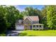 Attractive two-story home featuring a stone facade, inviting front porch, and a well-manicured lawn at 973 Rebecca Ln, Siler City, NC 27344