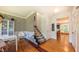 Foyer with hardwood flooring leads to a staircase with patterned carpet and view of living spaces at 973 Rebecca Ln, Siler City, NC 27344