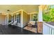 Charming front porch with comfortable seating, stone pillars, and a view of the tranquil surroundings at 973 Rebecca Ln, Siler City, NC 27344