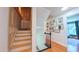 Hallway features access to stairs to attic and second floor and decorated with various wall art pieces at 973 Rebecca Ln, Siler City, NC 27344