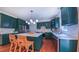 Bright kitchen features green cabinets, quartz countertops, stainless steel appliances, and an island with bar seating at 973 Rebecca Ln, Siler City, NC 27344