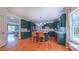 Charming kitchen with green cabinetry, island with seating, and view of dining room at 973 Rebecca Ln, Siler City, NC 27344