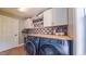 Spacious laundry area featuring matching washer and dryer beneath wood countertop and ample storage cabinets at 973 Rebecca Ln, Siler City, NC 27344