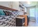 Well-organized laundry room with stylish tile backsplash, storage cabinets, sink and modern washer and dryer unit at 973 Rebecca Ln, Siler City, NC 27344