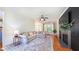 Open living room area with comfortable seating, fireplace and large windows at 973 Rebecca Ln, Siler City, NC 27344