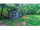 Backyard outbuilding with sliding door, offering extra storage or potential for a workshop at 973 Rebecca Ln, Siler City, NC 27344