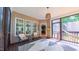 Cozy screened-in porch furnished with chairs, a table, and a view of the natural surroundings at 973 Rebecca Ln, Siler City, NC 27344