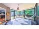 Relaxing screened-in porch with hammocks, stylish rug, and views of the surrounding greenery at 973 Rebecca Ln, Siler City, NC 27344