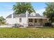 Home's exterior with backyard, patio, and mature trees at 1001 N Orange Ave, Dunn, NC 28334