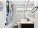 Bathroom with shower/tub combo, updated vanity, and tile flooring at 1001 N Orange Ave, Dunn, NC 28334