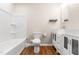 Bathroom featuring a modern vanity, sink, toilet, and shower-tub combo at 1001 N Orange Ave, Dunn, NC 28334