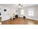 Bedroom with wood-look flooring, a ceiling fan, and windows with natural light at 1001 N Orange Ave, Dunn, NC 28334