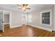 Bright bedroom featuring wood floors, a ceiling fan, and a closet at 1001 N Orange Ave, Dunn, NC 28334