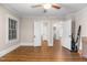 Open bedroom with wood floors, bright windows, and neutral paint at 1001 N Orange Ave, Dunn, NC 28334