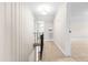 Hallway with carpet and wainscoting, leading to bedrooms and other areas at 1001 N Orange Ave, Dunn, NC 28334