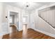 Hallway with staircase, chair rail, and view of the entryway and living area at 1001 N Orange Ave, Dunn, NC 28334