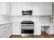 Modern kitchen with white cabinets, stainless steel appliances, and a built-in desk area at 1001 N Orange Ave, Dunn, NC 28334