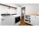 Laundry room with modern washer and dryer, storage shelves, and butcher block countertops at 1001 N Orange Ave, Dunn, NC 28334