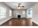 Bright living room featuring a decorative fireplace, wood floors, and natural light from large windows at 1001 N Orange Ave, Dunn, NC 28334
