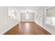 Bright living room featuring windows, a ceiling fan, and neutral paint at 1001 N Orange Ave, Dunn, NC 28334
