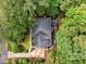 An aerial view showcasing the roof, deck, fire pit area, landscaping, and surrounding trees of the property at 1004 Staffield Lane Ln, Chapel Hill, NC 27516