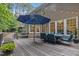 Expansive back deck with outdoor dining and seating areas, perfect for entertaining and enjoying the wooded view at 1004 Staffield Lane Ln, Chapel Hill, NC 27516