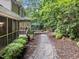 Beautiful backyard with a stone pathway, lush greenery, and a cozy deck area at 1004 Staffield Lane Ln, Chapel Hill, NC 27516