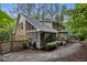 Exterior view of a charming home featuring a screened porch, deck, and beautiful landscaped yard at 1004 Staffield Lane Ln, Chapel Hill, NC 27516