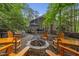 Backyard featuring an outdoor fire pit, deck, and lush greenery, ideal for outdoor gatherings and relaxation at 1004 Staffield Lane Ln, Chapel Hill, NC 27516