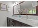Bathroom featuring double sinks, a large mirror, and modern fixtures at 1004 Staffield Lane Ln, Chapel Hill, NC 27516