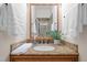 Bathroom featuring granite countertop and an elegant mirror reflecting the tiled walk-in shower at 1004 Staffield Lane Ln, Chapel Hill, NC 27516