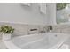 Luxurious soaking tub with marble surround and spa-like ambiance at 1004 Staffield Lane Ln, Chapel Hill, NC 27516