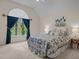 Bright bedroom featuring a large window with blue curtains and a queen size bed at 1004 Staffield Lane Ln, Chapel Hill, NC 27516