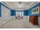 Bright bonus room with chair railing, blue walls, a ceiling fan, and bay window at 1004 Staffield Lane Ln, Chapel Hill, NC 27516