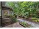 Scenic deck with planters and a stone pathway, offering a tranquil outdoor space with wooded backdrop at 1004 Staffield Lane Ln, Chapel Hill, NC 27516