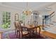 Dining room features hardwood floors, a classic chandelier, and a large window with natural light at 1004 Staffield Lane Ln, Chapel Hill, NC 27516