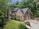 Two-story brick home featuring a manicured lawn, a two car garage, and tasteful landscaping at 1004 Staffield Lane Ln, Chapel Hill, NC 27516