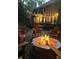 Exterior shot featuring a fire pit with burning logs and chairs in the backyard at 1004 Staffield Lane Ln, Chapel Hill, NC 27516